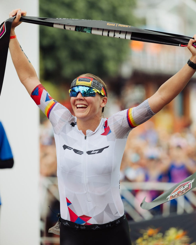 Triathlete celebrating at the finish line wearing an OMIUS cooling headband